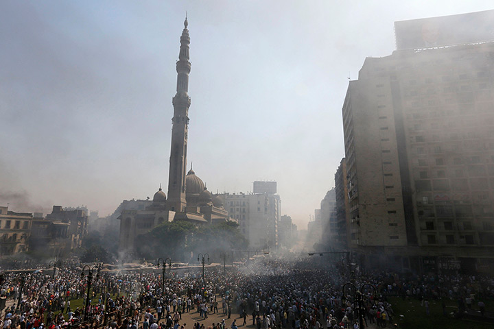 Smoke rises near Al-Fateh Mosque during clashes at Ramses Square in Cairo