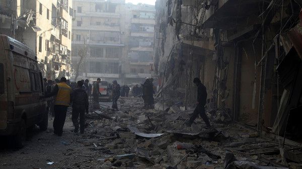 People inspect a damaged site after what activists said was an air raid by forces loyal to Syrian President Bashar Al-Assad, in Aleppo's district of Al Sukari