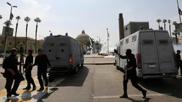 Riot police fire tear gas during a demonstration at the front of Cairo University
