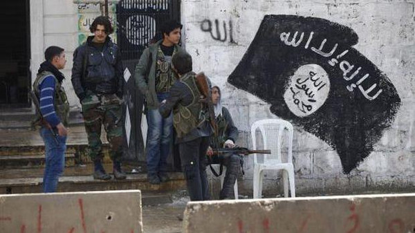 Free Syrian Army fighters stand at a former base used by fighters from the Islamic State in Iraq and the Levant (ISIL), after the ISIL withdrew from the town of Azaz, near the Syrian-Turkish border
