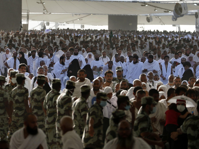 Muslim pilgrims arrive to cast stones at pillars symbolizing Satan, during the annual haj pilgrimage, on the first day of Eid al-Adha in Mina