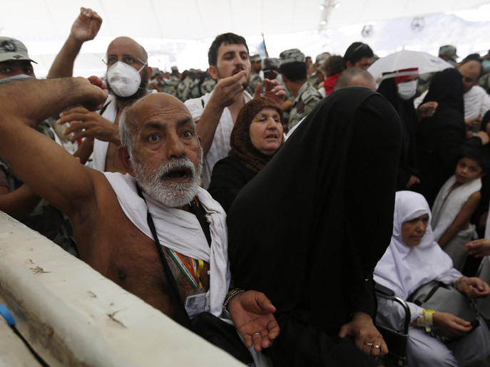 Muslim pilgrims cast stones at pillars symbolizing Satan, during the annual haj pilgrimage on the first day of Eid al-Adha in Mina