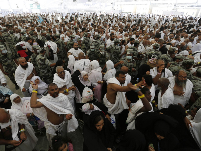 Muslim pilgrims cast stones at pillars symbolizing Satan, during the annual haj pilgrimage on the first day of Eid al-Adha in Mina