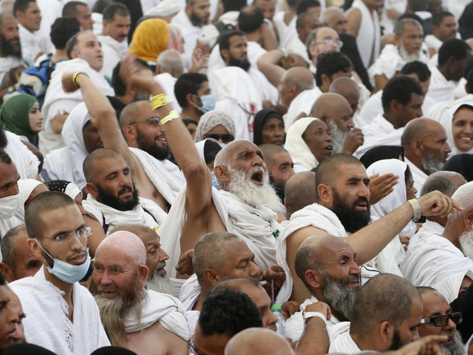 Muslim pilgrims arrive to cast stones at pillars symbolizing Satan, during the annual haj pilgrimage, on the first day of Eid al-Adha in Mina