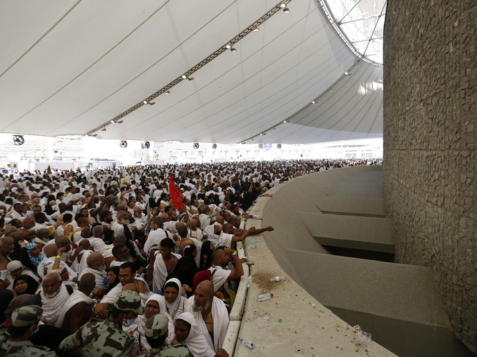 Muslim pilgrims cast stones at pillars symbolizing Satan, during the annual haj pilgrimage on the first day of Eid al-Adha in Mina