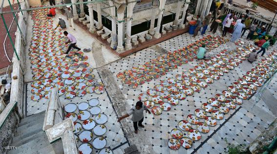 Indian Muslims lay out food for Iftar, the breaking of fast during Ramadan at the Alif Ni Masjid in Ahmedabad on July 27, 2014.   The Iftar, for people who come to shop in the Teen Darwaja area of Ahmedabad, was organised by the Khwaja Garib Nawaz Khidmat Patharna Bazar.  Across the Muslim world, the faithful fast from dawn to dusk and abstain from eating, drinking, smoking and having sex during the Holy Month of Ramadan as they strive to be more pious and charitable.  AFP PHOTO / Sam PANTHAKY        (Photo credit should read SAM PANTHAKY/AFP/Getty Images)