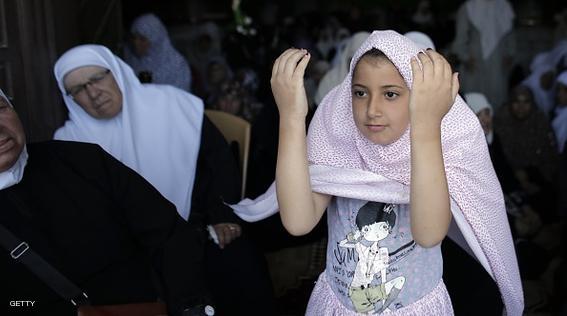 A Palestinian Muslim girl stands among worshipers praying inside the Dome of the Rock at the Al-Aqsa Mosque compound in Jerusalem during the first Friday prayer of the holy month of Ramadan, on June 19, 2015. Israel announced it was relaxing restrictions on the movement of Palestinians to and from the West Bank and Gaza Strip, ahead of the Muslim holy month of Ramadan. Men aged over 40 and women of all ages from the West Bank will be able to pray at the Israeli-controlled holy site, and 800 people from the Gaza Strip will be allowed to attend Friday prayers. AFP PHOTO/AHMAD GHARABLI        (Photo credit should read AHMAD GHARABLI/AFP/Getty Images)
