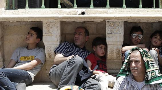 Palestinian Muslim worshipers protect themselves from the sun at the Al-Aqsa Mosque compound in Jerusalem during the second  Friday prayer of the holy month of Ramadan, on June 26, 2015. AFP PHOTO/AHMAD GHARABLI        (Photo credit should read AHMAD GHARABLI/AFP/Getty Images)