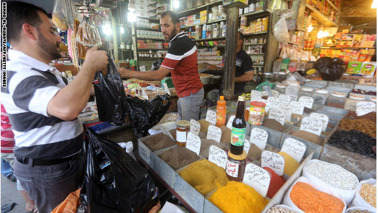 An Iraqi does some shopping at Shorja market in central Baghdad on June 16, 2015, as people prepare for the holy month of Ramadan due to start this week.   AFP PHOTO / AHMAD AL-RUBAYE        (Photo credit should read AHMAD AL-RUBAYE/AFP/Getty Images)