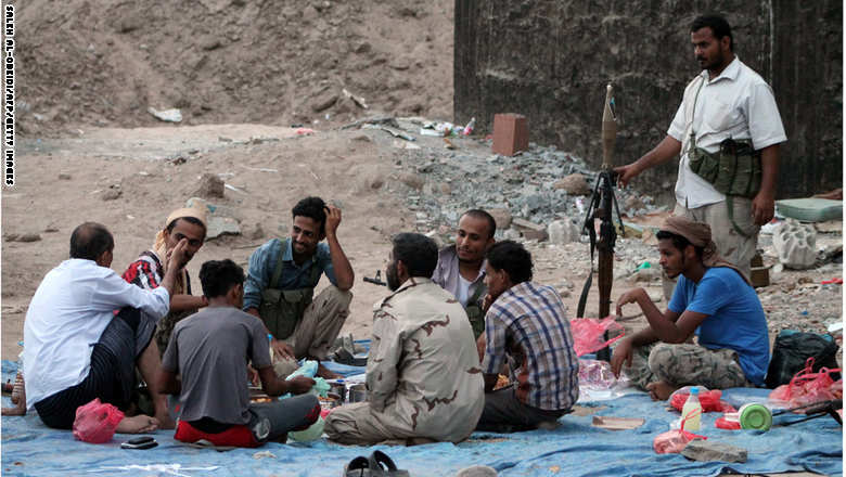 Yemeni fighters of the southern separatist movement, loyal to exiled President Abedrabbo Mansour Hadi, break their fast during the holy month of Ramadan on June 21, 2015, in Aden's Dar Saad suburb. Shelling by Shiite Huthi militiamen and troops loyal to ex-president Ali Abdullah Saleh of residential areas in Aden killed at least three civilians, as air strikes by the Saudi-led coalition also hit the southern city. AFP PHOTO / SALEH AL-OBEIDI        (Photo credit should read SALEH AL-OBEIDI/AFP/Getty Images)