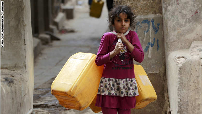A Yemeni girl carries jerrycans to fill them with water from a public tap amid an acute shortage of water supply to houses during the fasting month of Ramadan in the capital Sanaa, on June 21, 2015. AFP PHOTO / MOHAMMED HUWAIS        (Photo credit should read MOHAMMED HUWAIS/AFP/Getty Images)