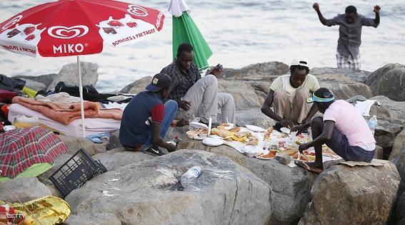 Migrants break their fast with the "iftar" meal during the Muslim fasting month of Ramadan in the city of Ventimiglia on the French-Italian border on June 24, 2015. Italy warned today that EU solidarity is at stake if the 28-nation bloc fails to reach a deal on sharing the burden of the Mediterranean migrant crisis.  AFP PHOTO / VALERY HACHE        (Photo credit should read VALERY HACHE/AFP/Getty Images)