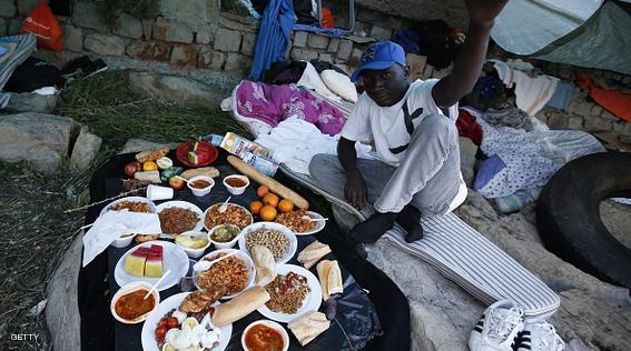 A migrant prepares to break his fast with the "iftar" meal during the Muslim fasting month of Ramadan in the city of Ventimiglia on the French-Italian border on June 24, 2015. Italy warned today that EU solidarity is at stake if the 28-nation bloc fails to reach a deal on sharing the burden of the Mediterranean migrant crisis.  AFP PHOTO / VALERY HACHE        (Photo credit should read VALERY HACHE/AFP/Getty Images)