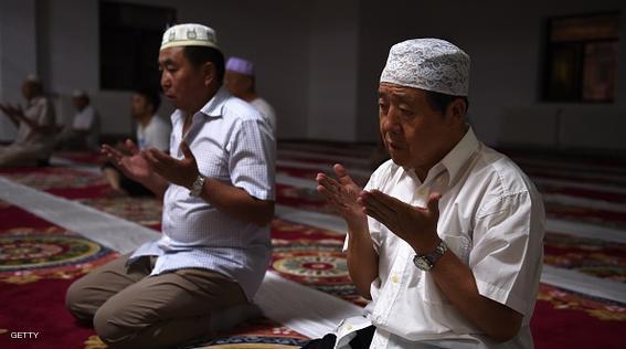 Muslims pray after breaking their fast on the first day of Ramadan, the muslim holy month, at a mosque in Beijing on June 18, 2015. China has banned civil servants, students and teachers in its mainly Muslim Xinjiang region from fasting during Ramadan and ordered restaurants to stay open, official websites showed as the holy month began on June 18.  AFP PHOTO / GREG BAKER        (Photo credit should read GREG BAKER/AFP/Getty Images)