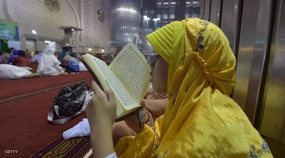 An Indonesian young girl reads a copy of Koran during the month of Ramadan at the Istiqlal mosque in Jakarta on June 21, 2015. More than 1.5 billion Muslims around the world celebrate the month with fast from dawn to dusk and conduct night prayers. AFP PHOTO / ADEK BERRY        (Photo credit should read ADEK BERRY/AFP/Getty Images)