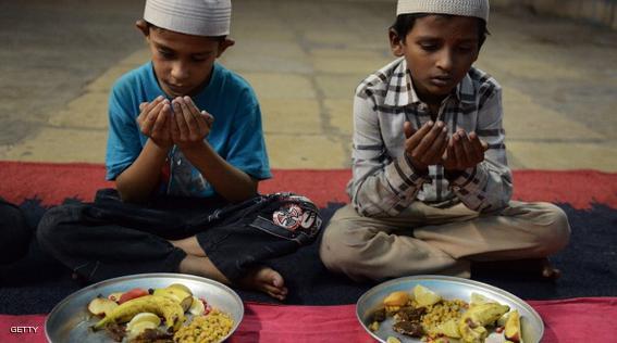 Indian Muslim children offer prayers prior to breaking their fast during of the holy fasting month of Ramadan at the Anees-Ul-Ghurba orphanage in Hyderabad on July 22, 2014. Like millions of Muslim around the world, Indian Muslims celebrated the month of Ramadan by abstaining from eating, drinking, and smoking as well as sexual activities from dawn to dusk. AFP PHOTO/NOAH SEELAM        (Photo credit should read NOAH SEELAM/AFP/Getty Images)