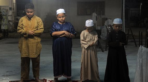 Thai Muslim boys offer prayers at a mosque during the month of Ramadan in Thailand's southern province of Narathiwat on June 29, 2015.  Muslims fasting in the month of Ramadan must abstain from food, drink and sex from dawn until sunset, when they break their fast with a meal known as Iftar.  AFP PHOTO / Madaree TOHLALA        (Photo credit should read MADAREE TOHLALA/AFP/Getty Images)