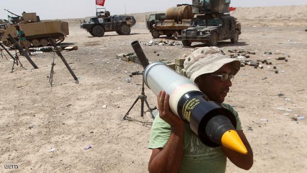 An Iraqi soldier carries a shell as forces supporting the government guard a position on July 15, 2015 on the northern outskirts of the city of Fallujah, west of the capital Baghdad, during an offensive to retake the Anbar capital, Ramadi. Iraqi security forces, Shiite paramilitaries and Sunni tribal fighters advanced towards Ramadi and Fallujah, the two main cities in the western province of Anbar in their latest push to recapture the capital from Islamic State (IS) group's jihadists.  AFP PHOTO / AHMAD AL-RUBAYE        (Photo credit should read AHMAD AL-RUBAYE/AFP/Getty Images)