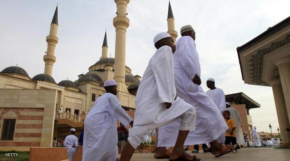 Sudanese men and children arrive to perform the early morning Eid Al-Fitr prayer in the eastern city of Omar Al-Mukhtar on September 10, 2010 as Muslims around the world start celebrating the three-day holiday that marks the end of the fasting month of Ramadan. AFP PHOTO/ASHRAF SHAZLY (Photo credit should read ASHRAF SHAZLY/AFP/Getty Images)