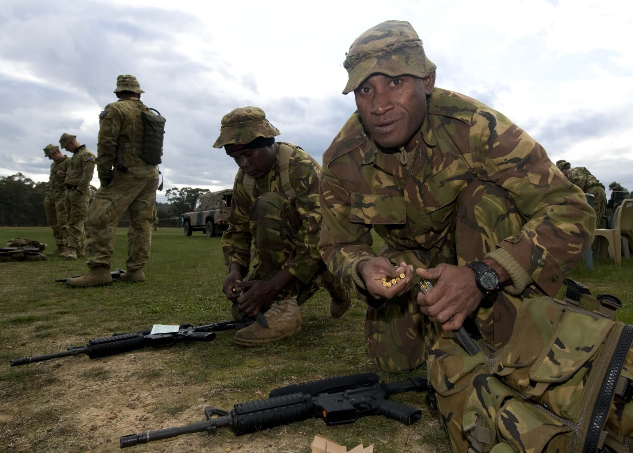 Caption; CAPT Christopher Kalvale of the Papua New Guinea Defence Force (PNGDF) loads his magazines before shooting at the Australian Army Skill at Arms Meeting (AASAM) AASAM 2010 This year's Australian Army Skill at Arms Meeting (AASAM), conducted at Puckapunyal Military Range, is designed to pitch the best soldiers against each other in a tough combat-like environment. This focus ensures the contest is more representative of the skills required of a modern fighting soldier. Since 1984, AASAM has been Australia's premier military shooting tournament, with a worldwide reputation. The activity is open to all ADF members and also attracts similar champions from international Defence Forces. This year includes teams from Thailand, France, Singapore, Canada, Brunei, Philippines, East Timor, Papua New Guinea and Indonesia.   Irrespective of nationality, the common language is marksmanship. The competition will be judged through a series of team and individual events encompassing both day and night shooting from close quarters out to 400 metres. Contestants will fire the pistol, rifle and machine gun as standard issue for their Defence Force. The competition decides the champion shot of the ADF, as well as providing a venue to determine who is the best shooting unit and formation in the Australian Army. The international aspect of the competition determines the best individual shooter and competing nation. Matches are designed to replicate some of the conditions and stressors of current operational environments and is an excellent means to validate current doctrine and evaluate training standards.