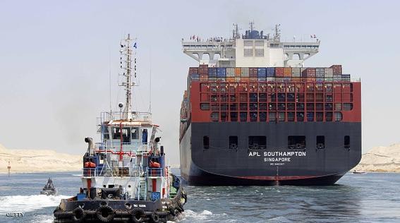 Boats, including a container ship, cross the new waterway of the Suez canal on July 25, 2015, in the Egyptian port city of Ismailia, east of Cairo. Egypt began the first trial run of its "new Suez canal," officials and state media said, ahead of the formal inauguration of the new shipping route on August 6. Dubbed the Suez Canal Axis, the new 72-kilometre (45 mile) project is aimed at speeding up traffic along the existing waterway by reducing the waiting period of vessels, as well as boosting revenues for Egypt.  AFP PHOTO / STR        (Photo credit should read -/AFP/Getty Images)