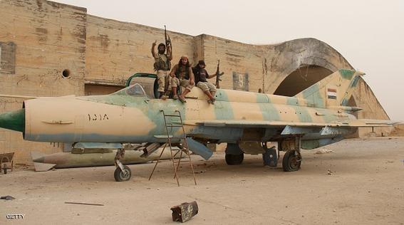 Members of Al-Qaeda's Syrian affiliate and its allies sit on top of a former Syrian army figther jet after they seized the Abu Duhur military airport, the last regime-held military base in northwestern Idlib province on September 9, 2015 in the latest setback for President Bashar al-Assad's forces. Al-Nusra Front and a coalition of mostly Islamist groups captured the military airport after a siege that lasted two years, the Syrian Observatory for Human Rights monitor said. AFP PHOTO / OMAR HAJ KADOUR        (Photo credit should read OMAR HAJ KADOUR/AFP/Getty Images)