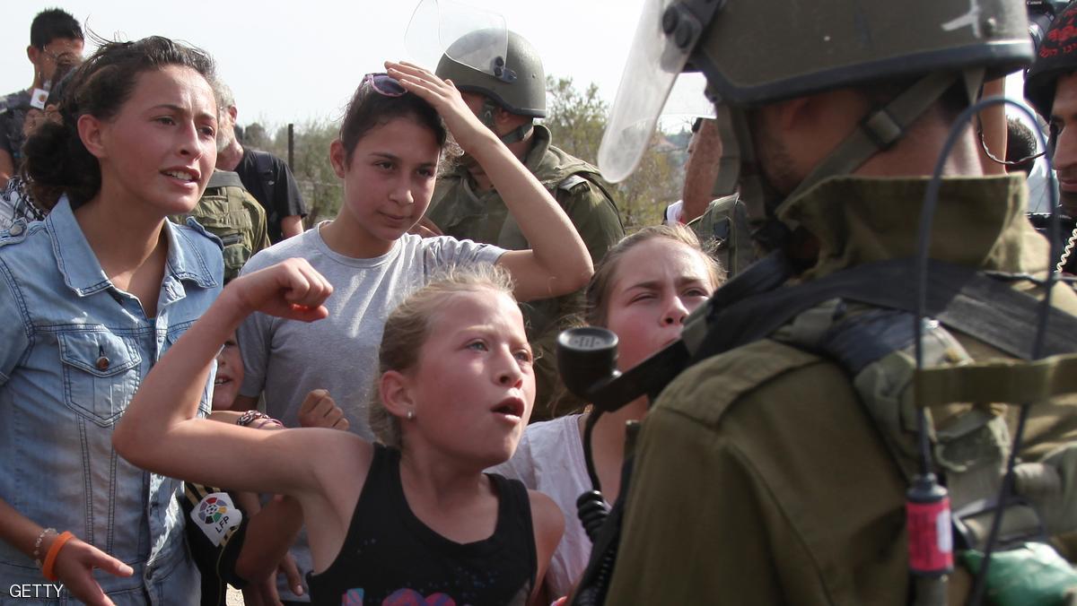 Palestinian demonstrators shout slogans in front of an Israeli soldier during a protest against the confiscation of Palestinian land by Israel in the West Bank village of Nabi Saleh near Ramallah on November 2, 2012. AFP PHOTO/ABBAS MOMANI        (Photo credit should read ABBAS MOMANI/AFP/Getty Images)