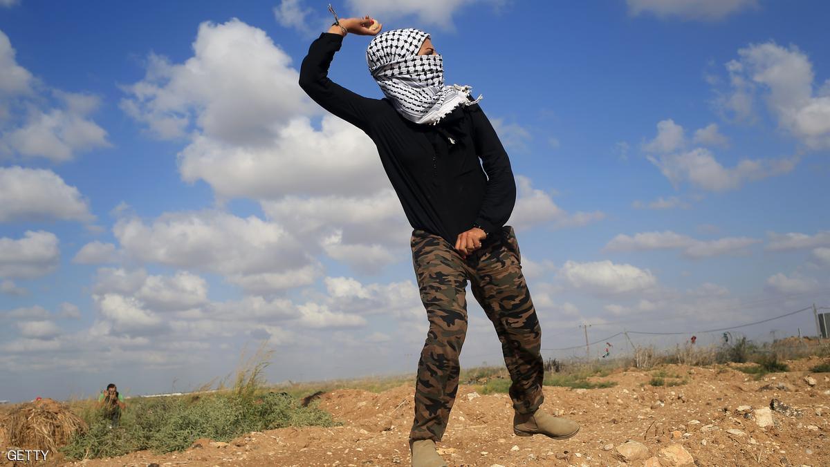 A Palestinian woman throws stones during clashes with Israeli security forces near the border fence between Israel and the Gaza Strip on October 9, 2015 east of Gaza City. A week of violence between Israelis and Palestinians spread to the Gaza Strip, with Israeli troops killing five people in clashes on the border and Islamist movement Hamas calling for more unrest. AFP PHOTO / MOHAMMED ABED (Photo credit should read MOHAMMED ABED/AFP/Getty Images)