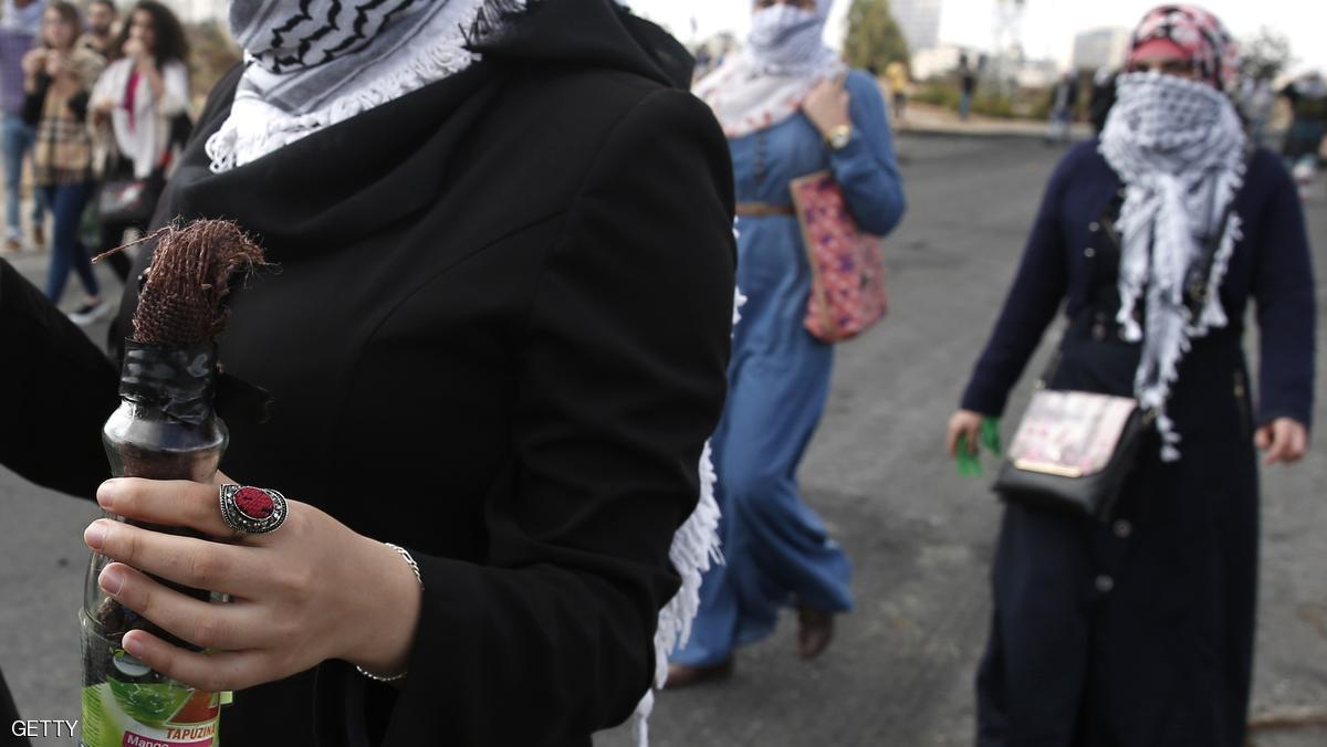A Palestinian young woman from the Birzeit University holds a Molotov cocktail during clashes between stone throwers and Israeli security forces in Beit El, on the outskirts of the West Bank city of Ramallah, on October 7, 2015. New violence rocked Israel and the Israeli-occupied West Bank, including a stabbing in annexed east Jerusalem, even as Israel and Palestinian president Mahmud Abbas took steps to ease tensions. AFP PHOTO / ABBAS MOMANI (Photo credit should read ABBAS MOMANI/AFP/Getty Images)