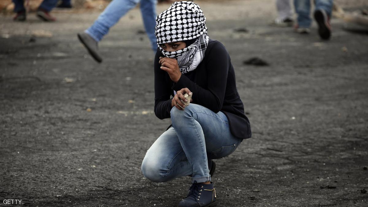 A Palestinian young woman from the Birzeit University looks on during clashes with Israeli security forces in Beit El, on the outskirts of the West Bank city of Ramallah, on October 7, 2015. New violence rocked Israel and the Israeli-occupied West Bank, including a stabbing in annexed east Jerusalem, even as Israel and Palestinian president Mahmud Abbas took steps to ease tensions. AFP PHOTO / ABBAS MOMANI (Photo credit should read ABBAS MOMANI/AFP/Getty Images)