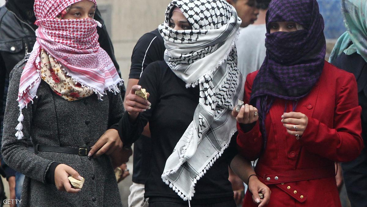 Palestinian young women hold stones during clashes with Israeli security forces in the West Bank town of Hebron on October 7, 2015. New violence rocked Israel and the Israeli occupied West Bank, including an incident in which men thought to be undercover Israeli police opened fire on Palestinian stone throwers they had infiltrated, wounding three of them. AFP PHOTO / HAZEM BADER (Photo credit should read HAZEM BADER/AFP/Getty Images)