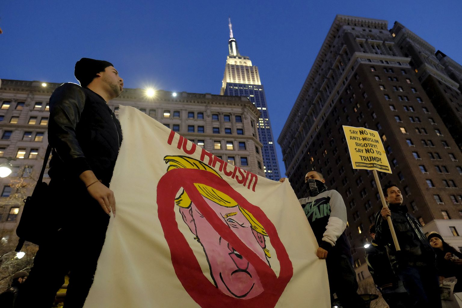 The Empire State Building is seen in the background as people take part in a protest against U.S. Republican presidential candidate Donald Trump in Manhattan, New York, December 20, 2015. REUTERS/Eduardo Munoz