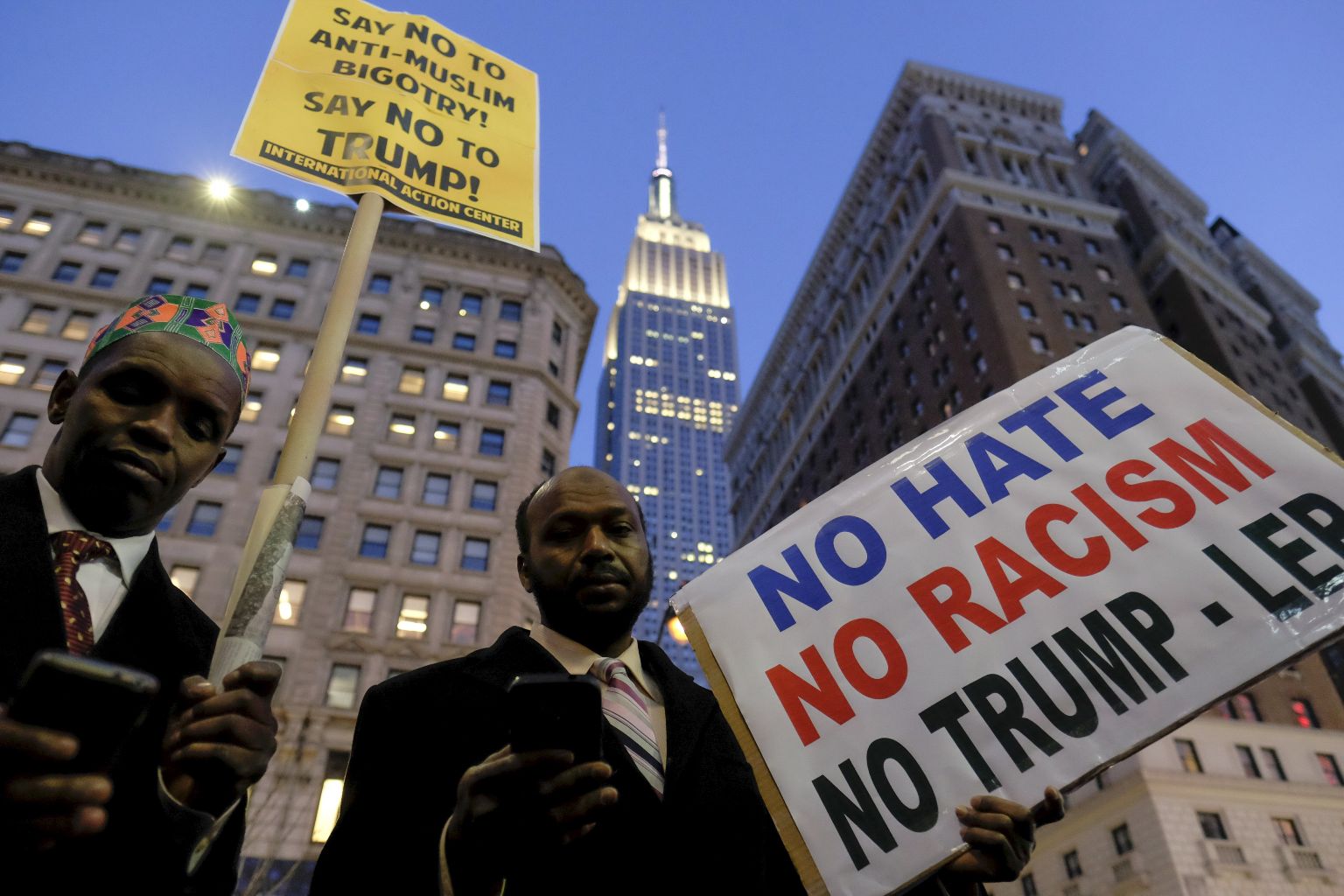The Empire State Building is seen at the background as people take part in a protest against presidential candidate Donald Trump in Manhattan, New York December 20, 2015. REUTERS/Eduardo Munoz