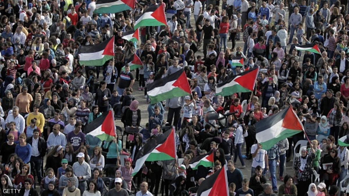 Arab-Israelis wave Palestinian flags during a demonstration marking Land Day on March 30, 2015 in the northern Arab-Israeli village of Deir Hanna in the northern Galilee region. On the annual Land Day, demonstrations are held to remember six Arab Israeli protesters who were shot dead by Israeli police and troops during mass demonstrations in 1976 against plans to confiscate Arab land in the Galilee. AFP PHOTO / AHMAD GHARABLI (Photo credit should read AHMAD GHARABLI/AFP/Getty Images)