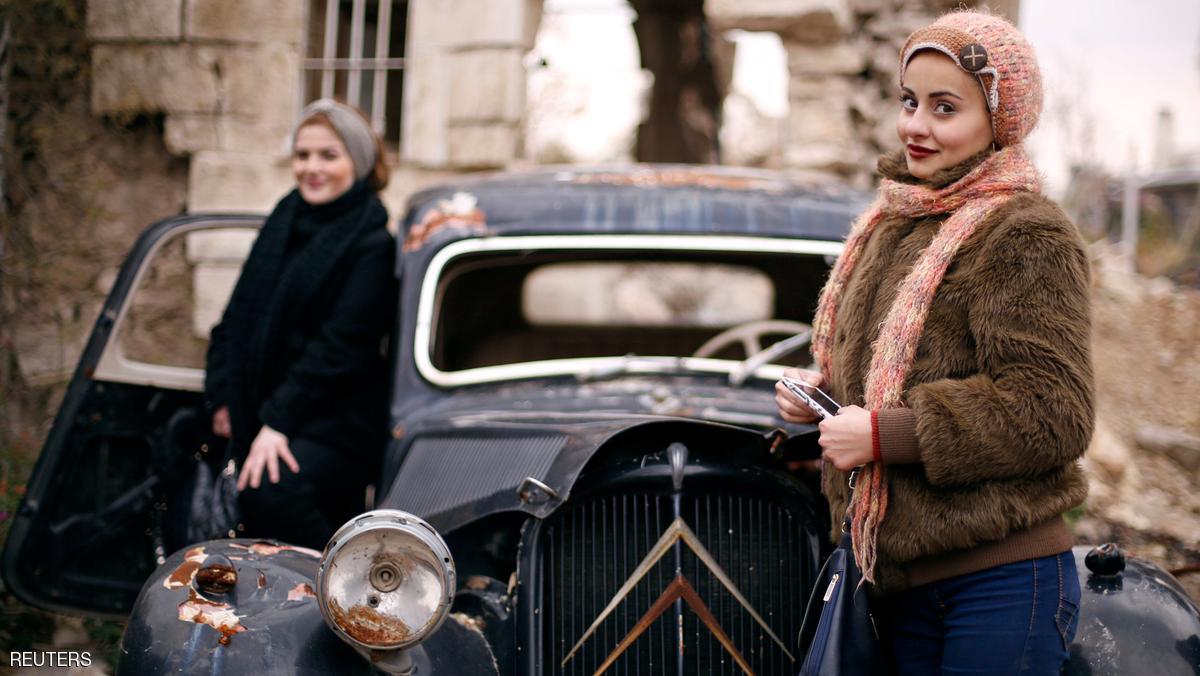 Women pose for a picture at the entrance of the Carlton Hotel, in the government controlled area of Aleppo, Syria December 17, 2016. REUTERS/ Omar Sanadiki TPX IMAGES OF THE DAY